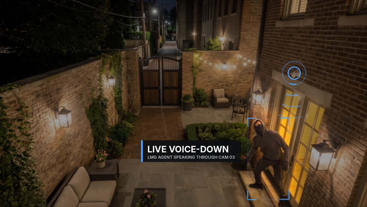 An intruder by the French doors looking up at the camera, labeled Live Voice-Down